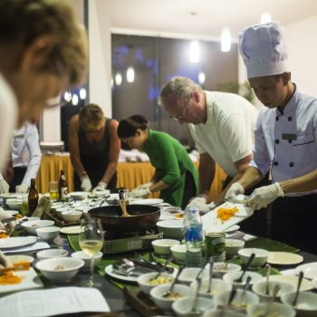 Tourists learn to cook vietnamese food in Cooking Class