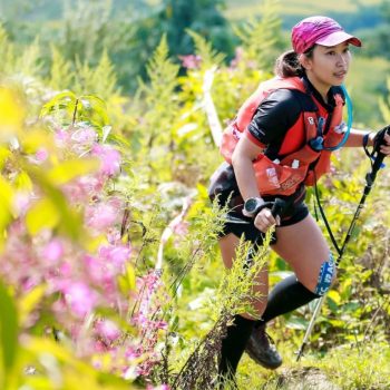 Trail runner, running through beautiful flower nature in Vietnam Mountain marathon